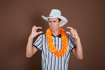 Cheerful young man in a hat and sunglasses. Long awaited vacation. Joyful emotions. Copy Space.