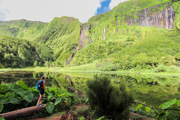View of the idyllic Po&ccedil;o da Alagoinha lagoon at Flores island in Azores

Several waterfalls that spring from the mountain and feed the lagoon in which they are reflected