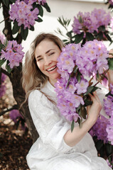 Laughing girl in the rhododendron bushes.