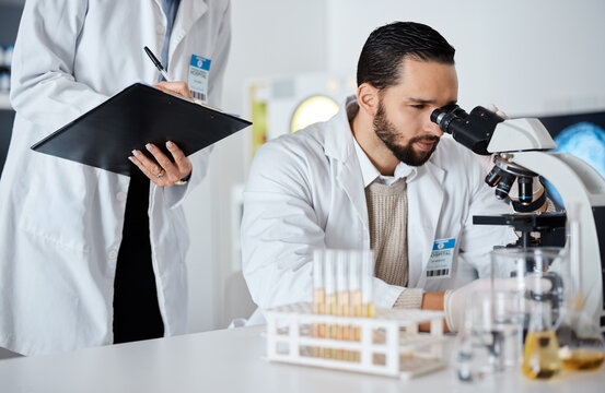 Scientist, Woman And Man By Microscope With Checklist In Laboratory For Research At Pharma Company. Science Team, Data Analytics And Biotechnology For Goals, Vision And Study Virus For Lab Innovation