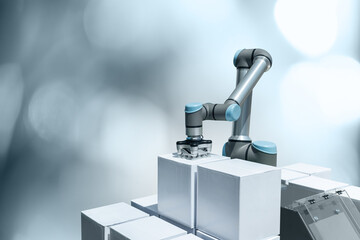 Robot arm with box on a gray background. Smart industry 4.0 concept	