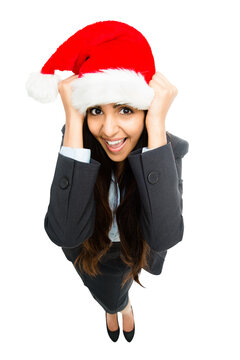 An attractive excited young indian businesswoman in a christmas hat ready for a christmans party or a celebration isolated on a png background.