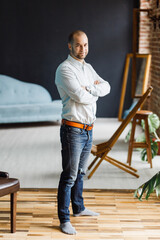 portrait of a thirty-year-old businessman in jeans and a shirt