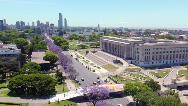 Traffic On The Thoroughfare In Buenos Aires, Argentina Passing By The University Of Buenos Aires Faculty Of Law. United Nations Square In Distance. wide aerial