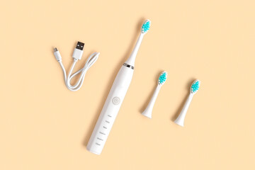 Electric Toothbrush. Top View, Flat Lay, Copy Space. Dental Care Supplies on Beige Pastel Studio...