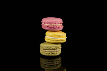 Colorful macaroon over black background