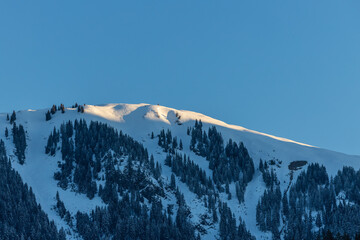 Bright sunlight  over snow covered mountains in the Austrian Alps - Ski resort Ktizbühel, Tirol
