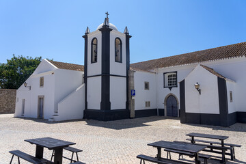 Beautiful church and square of the village of Aldeia Nova with the white typical facade in a sunny...