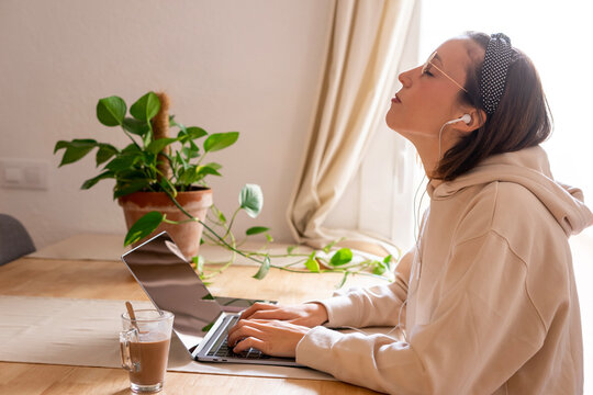 Girl Working At Home. Girl Shrugging Shoulders Because Of Back Pain	