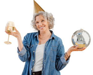One happy mature caucasian woman holding a disco ball and drinking a glass of white wine while wearing a birthday hat. Smiling white lady celebrating bithday isolated on a png background.