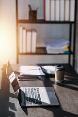 Asian Business woman using calculator and laptop for doing math finance on an office desk, tax, report, accounting, statistics, and analytical research concept