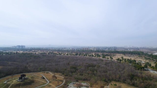 Aerial shot of Park - Aerial shot of F9 Fatima Jinnah Park Islamabad - Drone footage of Islamabad park with Centaurus mall in the background and trees of F9 Park Islamabad, Pakistan