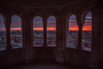Window to sunset over city