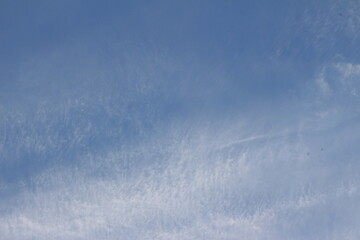 Blue sky and white clouds. Background. Layer. Texture. Seelctive focus. Out of focus. Copy space
