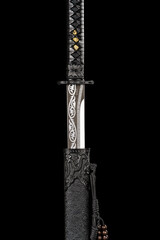 Long Chinese sword with black scabbard isolated on black background.