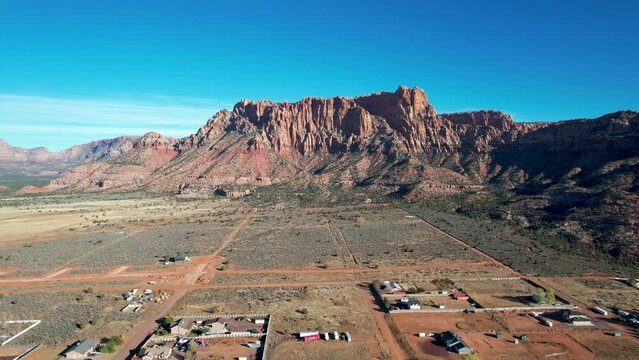 Red Rock Cliffs above Colorado City, Utah town -Drone zoom in