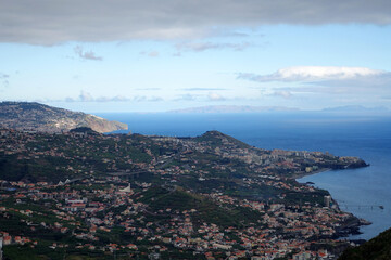 Fototapeta na wymiar A typical view across Madeira above Funchal, showing patchwork of fields and houses with tunnels