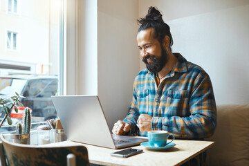 Cafe, happy or startup man on laptop planning on web SEO networking, social media or B2B sale....