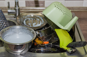 A lot of dirty dishes in the sink in the kitchen