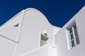 white building on Santorini island in Greece against blue sky