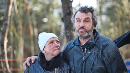 Homeless people are interviewed in the winter in the woods.