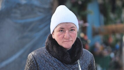 Portrait of a homeless woman in winter in the woods.