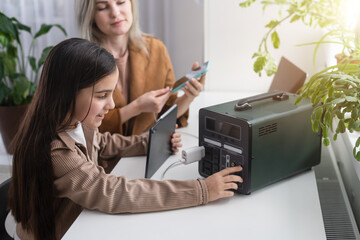 charge mobile phones, mother and daughter use a portable charging station.