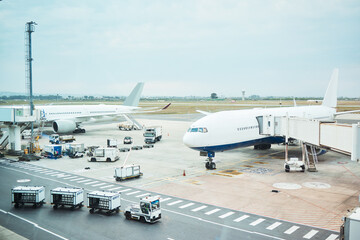 Fototapeta na wymiar Airplane at airport, stationary transport on tarmac and runway for international passenger travel on sky horizon. Plane on ground, outdoor flight terminal and cargo carrier on aeroplane runway