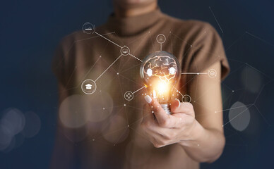 Hand holding light bulb, gears icon and brain inside the light bulb. Chart, graph, Ph.D, target...