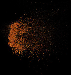 Fototapeta na wymiar Red Hot Chilli flying explosion, red grain chilli explode abstract cloud fly. Beautiful complete seed chilly splash in air, food object design. Selective focus freeze shot black background isolated