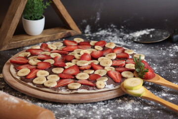 Strawberry, Banana, Nutella Spread Pizza. with rolling pin and pizza cutter