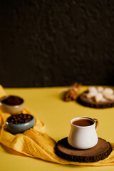 traditional Turkish coffee with coffee beans on yellow background 