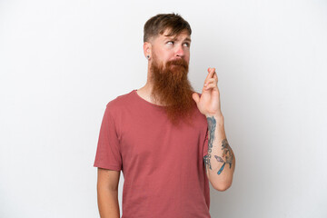 Redhead man with long beard isolated on white background with fingers crossing and wishing the best