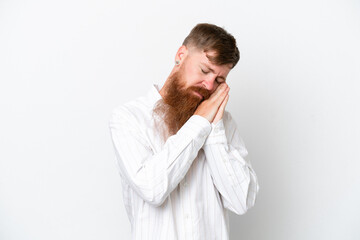 Redhead man with long beard isolated on white background making sleep gesture in dorable expression