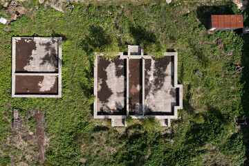 Overhead view of house foundation on a dacha land. Abandoned land with basement