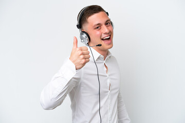 Telemarketer Brazilian man working with a headset isolated on white background with thumbs up because something good has happened