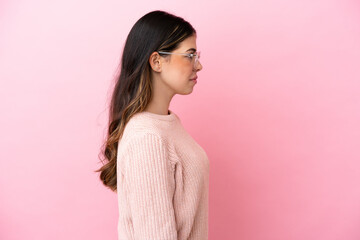 Fototapeta premium Young Italian woman isolated on pink background With glasses