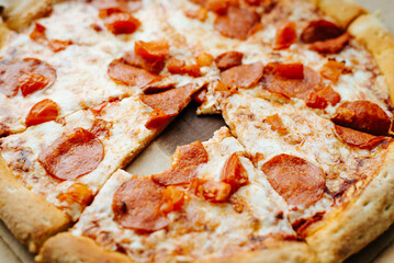 Close-up bitten off piece from pepperoni pizza