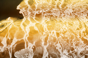 Blurred transparent Yellow Gold colour clear calm water surface texture with splashes and bubbles....