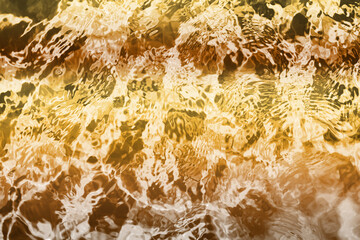 Blurred transparent Yellow Gold colour clear calm water surface texture with splashes and bubbles. Trendy abstract nature background. Water waves in sunlight. water background, oil