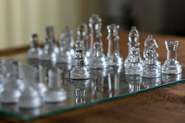 glass chess pieces on chessboard