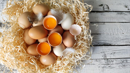 Chicken eggs. Cracked egg, raw yolk and white. - 570265392