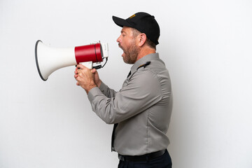 Middle age security man isolated on white background shouting through a megaphone