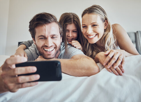 Portrait, relax or parents take a selfie with a girl as a happy family in house bedroom bonding in Berlin. Mother, father or child relaxing together enjoying quality time or taking pictures at home