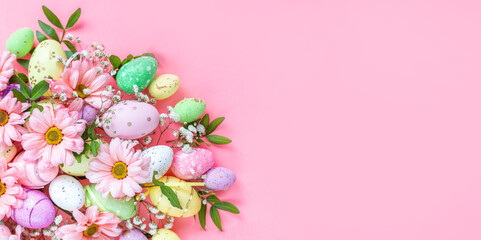 Fototapeta na wymiar Colorful eggs with flowers on a pink background. Easter card with space for text. Spring banner