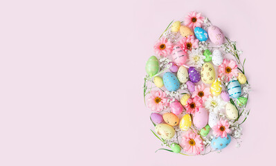 Easter egg shape with flowers and decorated eggs on pink background with copy space. Creative...