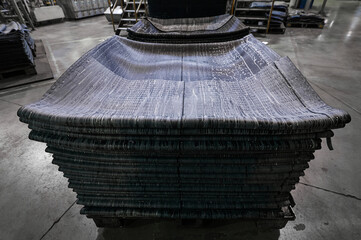 Stack of reinforced tire rubber sheets at production plant