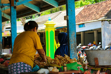Yogyakarta, Indonesia in November 2022. Women on Baron Beach work as traders at the fish market.