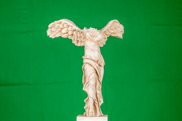 green screen background and solo female sculpture with wings, ancient god of victory Nike with a marble art work greek mythology - obrazy, fototapety, plakaty