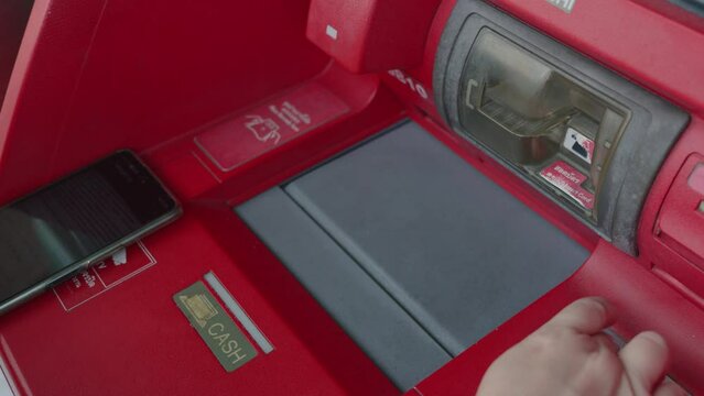 Woman's hand put cash into ATM deposit. Counting Thailand banknote money before deposit close up.